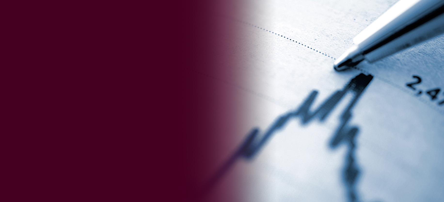 Close up of a ballpoint pen pointing to a line graph